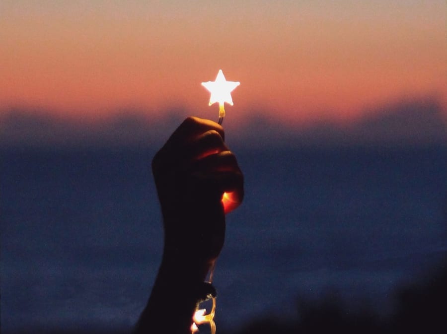 hand holding star shaped light