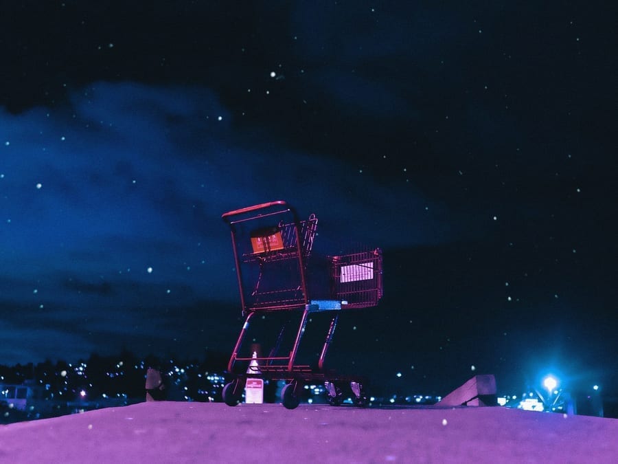 shopping cart in front of night sky