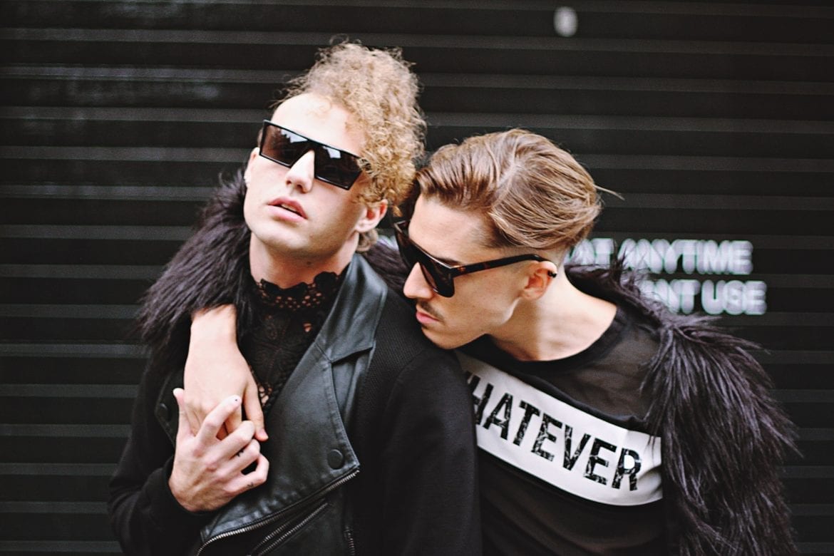 men in sunglasses and black outfits