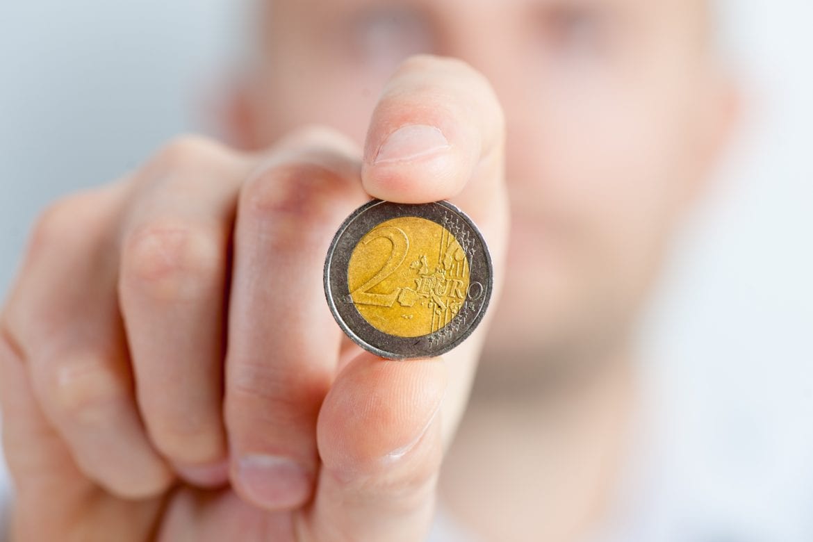 hand holding two euro coin