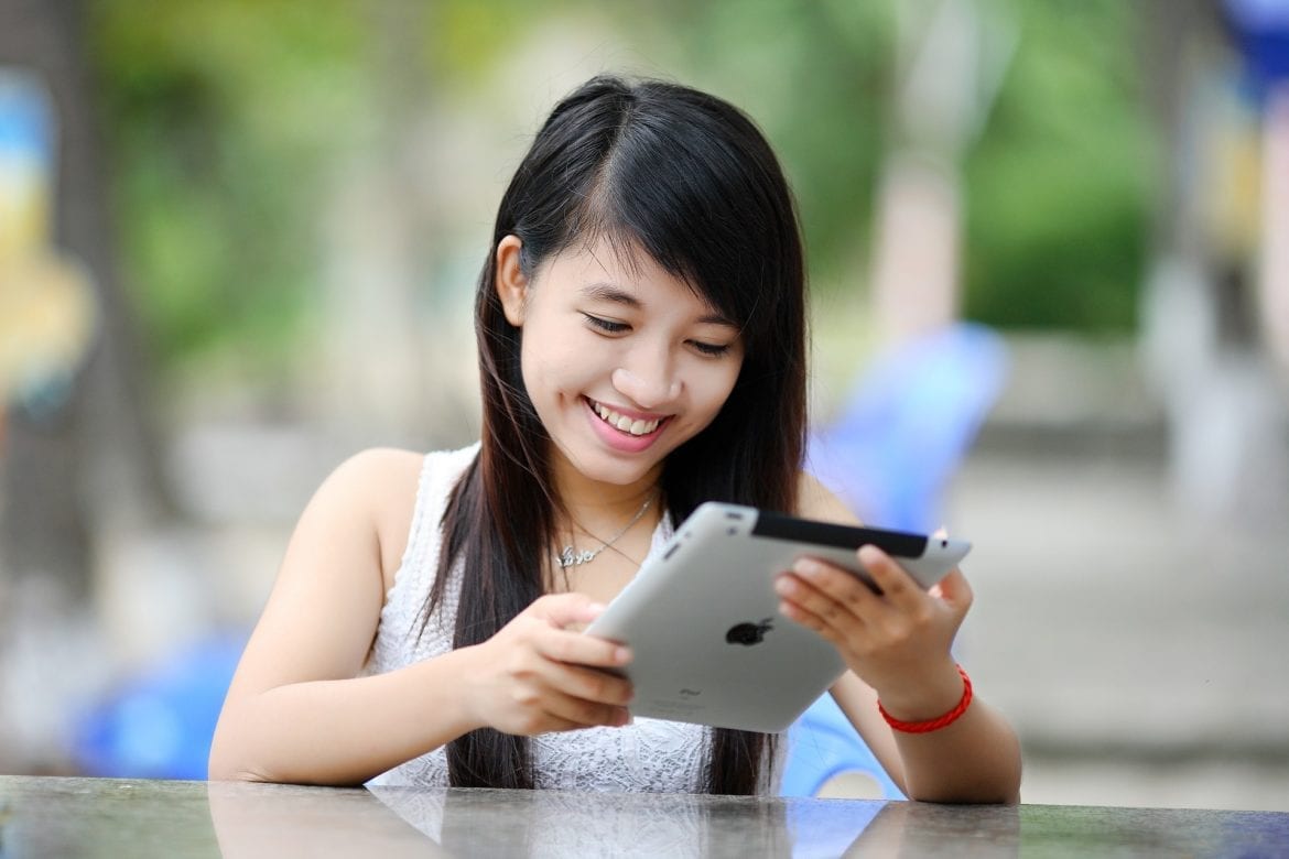 smiling woman using tablet