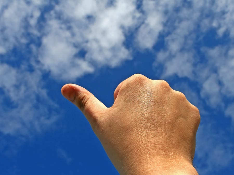 thumb pointing to the sky